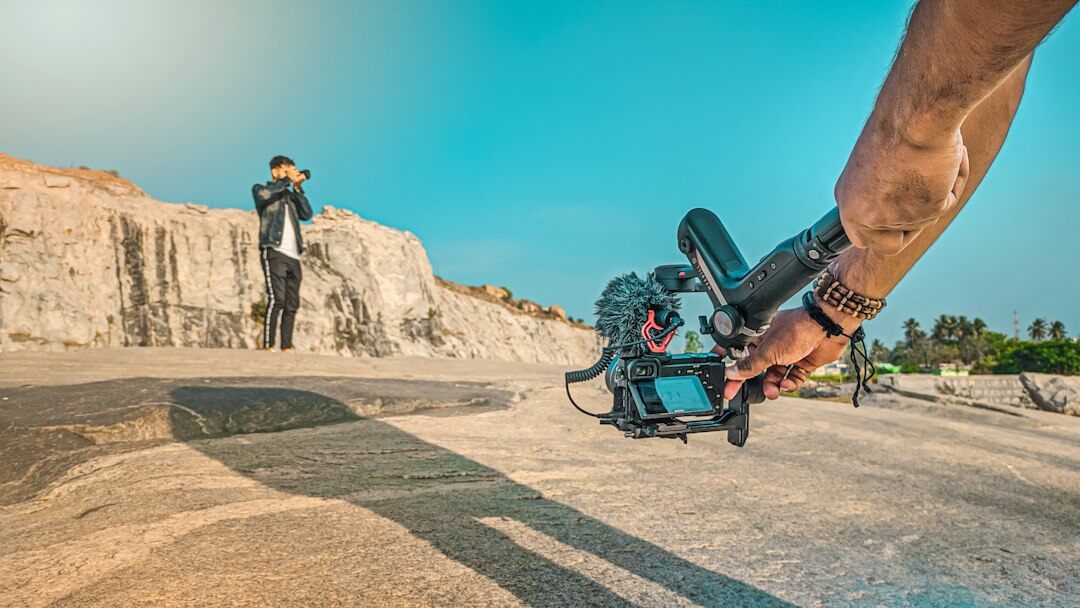 Camera operator filming with a professional broadcast camera